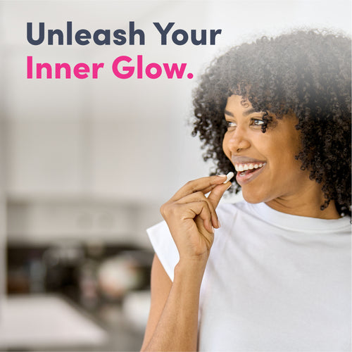 Young woman smiling holds a white capsule, ready to take MU Neocell Super Collagen.