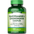 A hand holding Glucosamine & Chondroitin Complex bottle containing 120 tablets, emphasizing joint health and support.