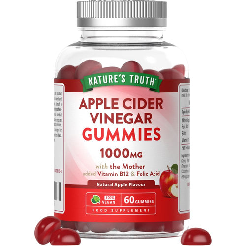 Apple-shaped Apple Cider Vinegar 1000MG gummies are spilling out of the jar onto the surface.
