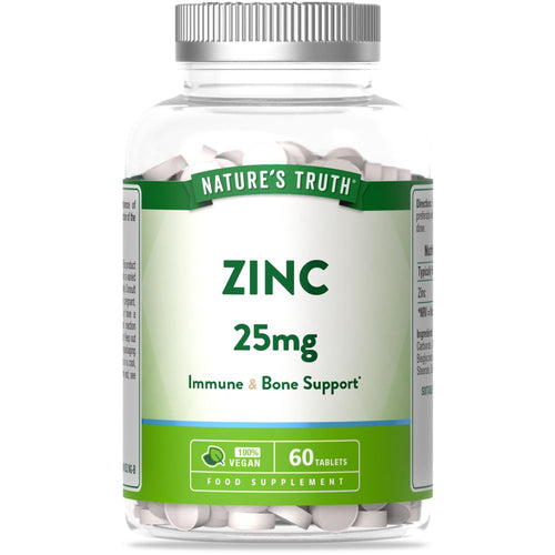 A hand holds a clear bottle of Nature's Truth Zinc 25mg, containing 60 vegan tablets.