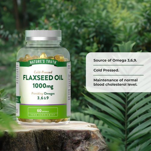 Hand holding a scale displaying a bottle of Flaxseed Oil 1000 mg with 60 softgels, reflecting weight measurement.