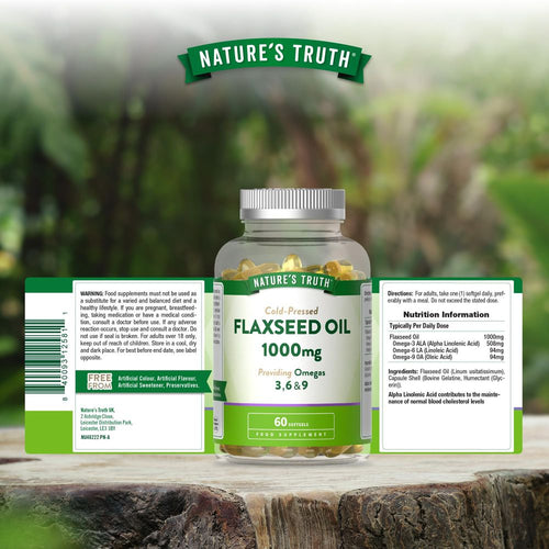 A bottle containing 60 yellow softgels of Cold-Pressed Flaxseed Oil 1000mg on a hand scale.