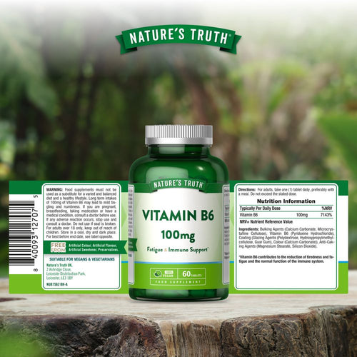 A bottle of Nature's Truth Vitamin B6, 100mg, containing 60 tablets, shown on a hand scale.