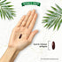 A dark red quick-release softgel on a hand, labeled 'Quick-release softgels', next to another softgel.
