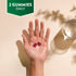 A hand holding two red NU Omega 369 & Multivitamin Vegetarian Gummies with text stating '2 GUMMIES DAILY'.