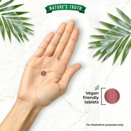 A round, reddish-purple Beetroot Extract tablet in hand with 'Vegan friendly tablets' text visible.