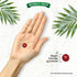 A single red Apple Cider Vinegar vegan gummy rests in a hand's palm. Text reads 'Vegan friendly gummies'.