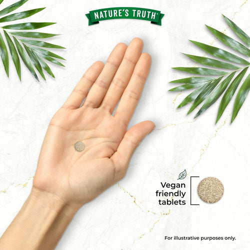 A hand holding a Dandelion Extract tablet with the text 'Vegan friendly tablets' displayed.
