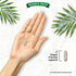 A single vegan-friendly light brown capsule rests in the palm of a hand, highlighting its compact size and portability.