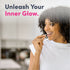 Young woman smiling holds a white capsule, ready to take MU Neocell Super Collagen.