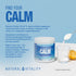 Natural Vitality Calm Relaxing Drink Mix unflavoured powder scooped from a 200g container into a glass.