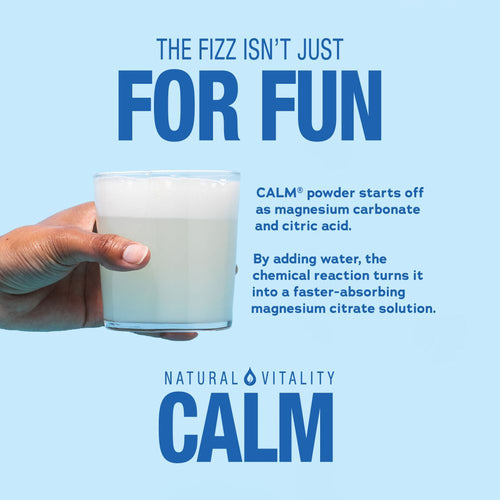 Hand holding glass of fizzy white Natural Vitality CALM drink. Text: 'THE FIZZ ISN'T JUST FOR FUN'. Powder becomes magnesium citrate solution.
