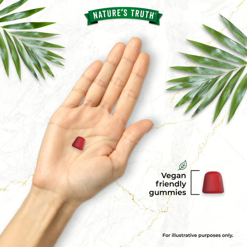 A hand holds a red gummy, with another red gummy beside the text 'Vegan friendly gummies'.
