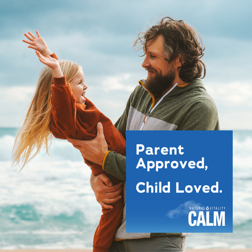 A man and a young girl laugh and play by the ocean, with a blue graphic overlay for Natural Vitality Calm.