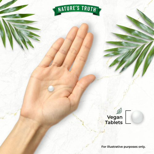 A person's hand holding a round white tablet. The words 'Vegan Tablets' are displayed.