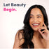 Young woman smiling, looking aside, hand on cheek, with 'Let Beauty Begin.' text for Neocell Collagen.